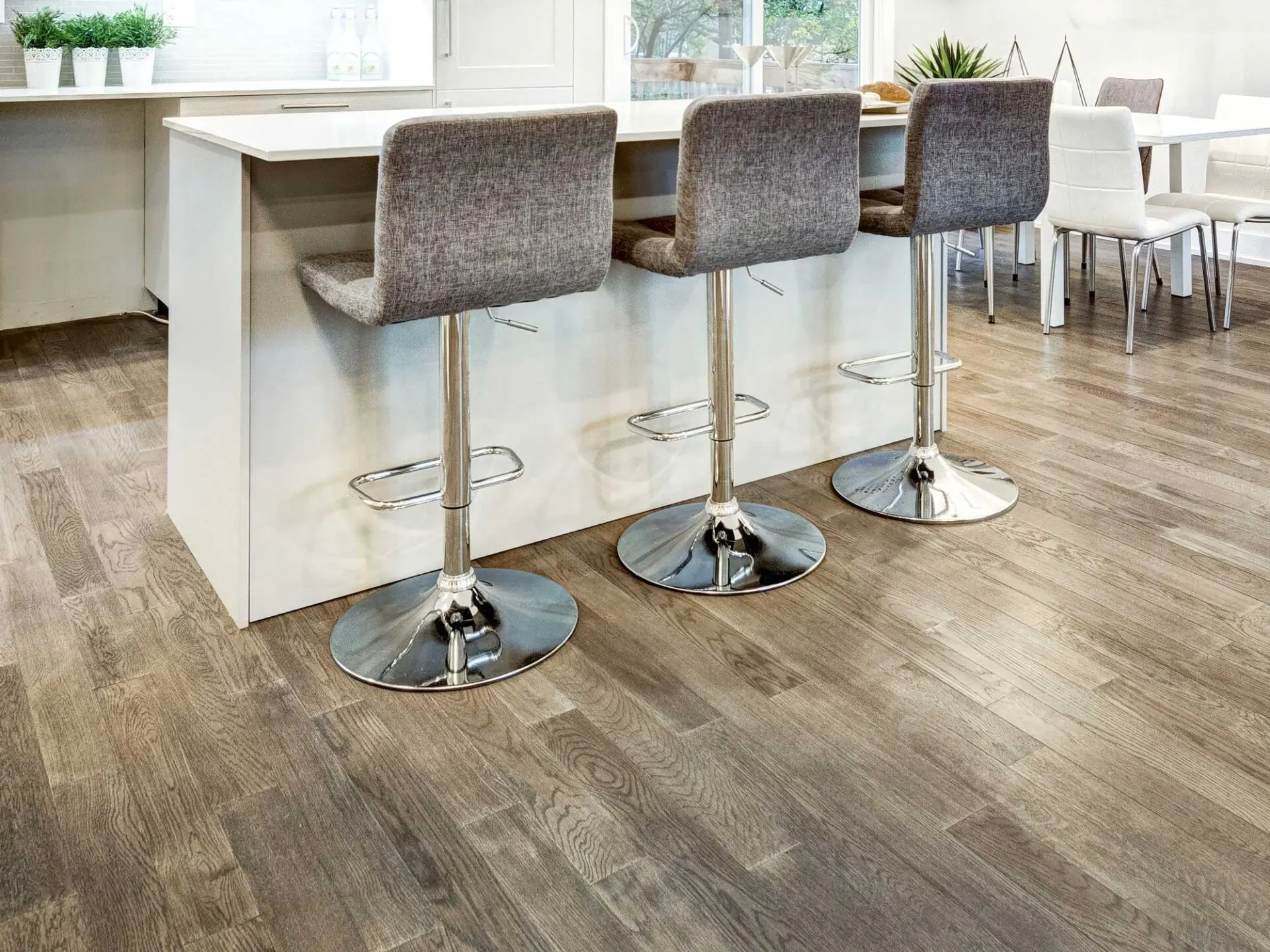 Comparison of hardwood, luxury vinyl, and tile flooring options for Kansas City homes