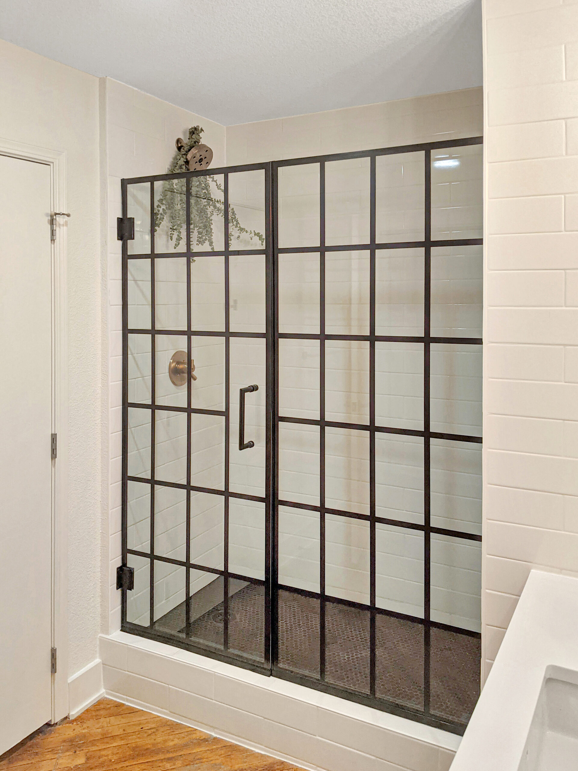 Tile shower subway tile walls and black mosaic shower pan Kansas City